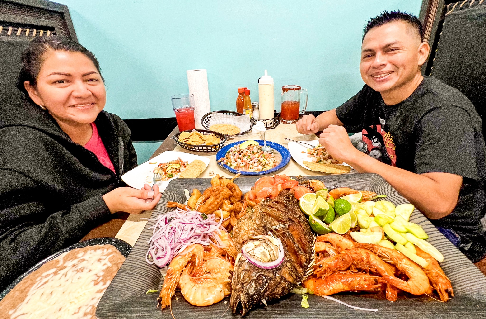 a husband and wife enjoying a seafood meal at omaha's mexican isla del marre restaurante