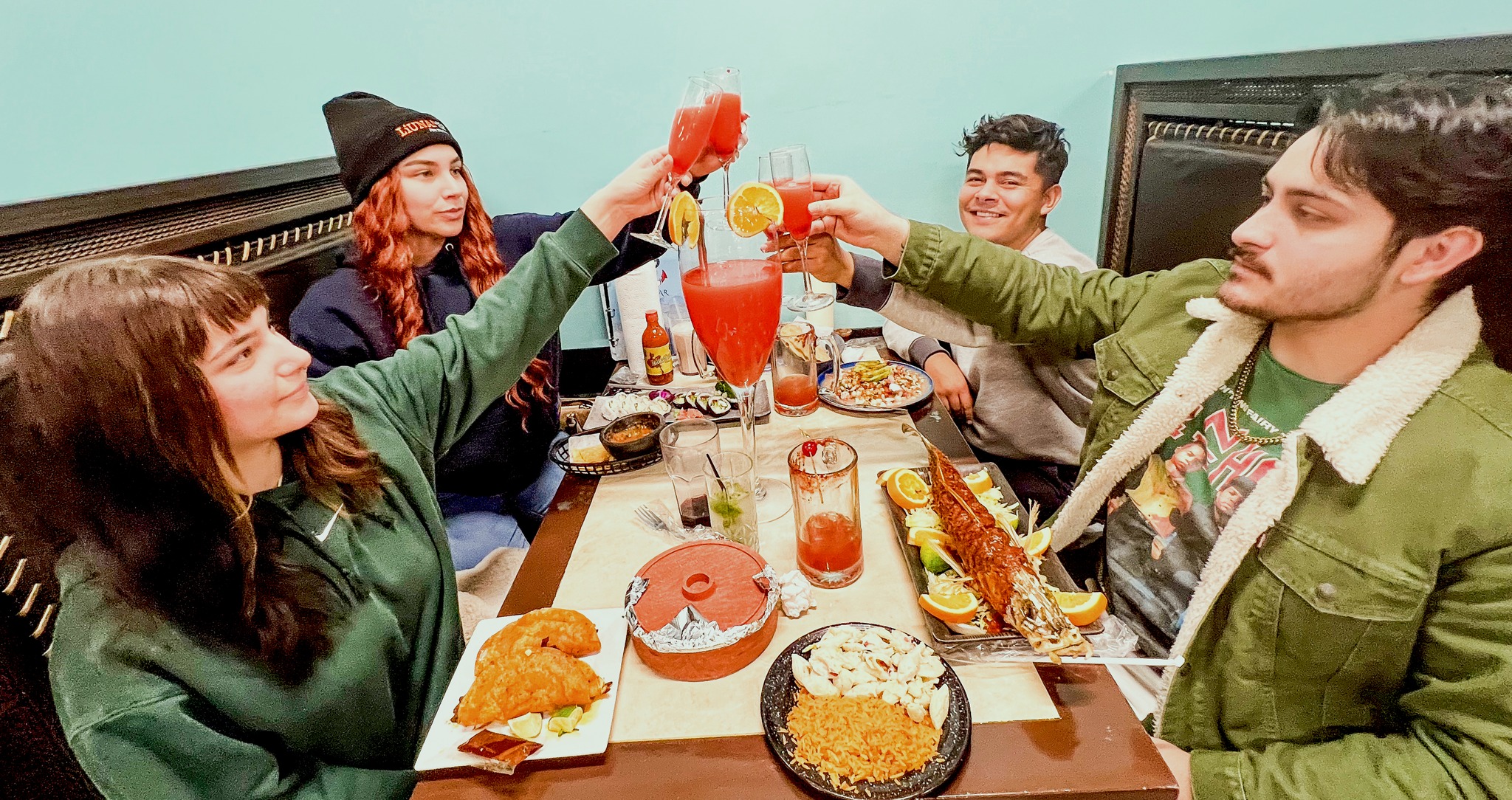 group of friends cheers-ing at isla del mar, one of omaha's Restaurants with Live Music